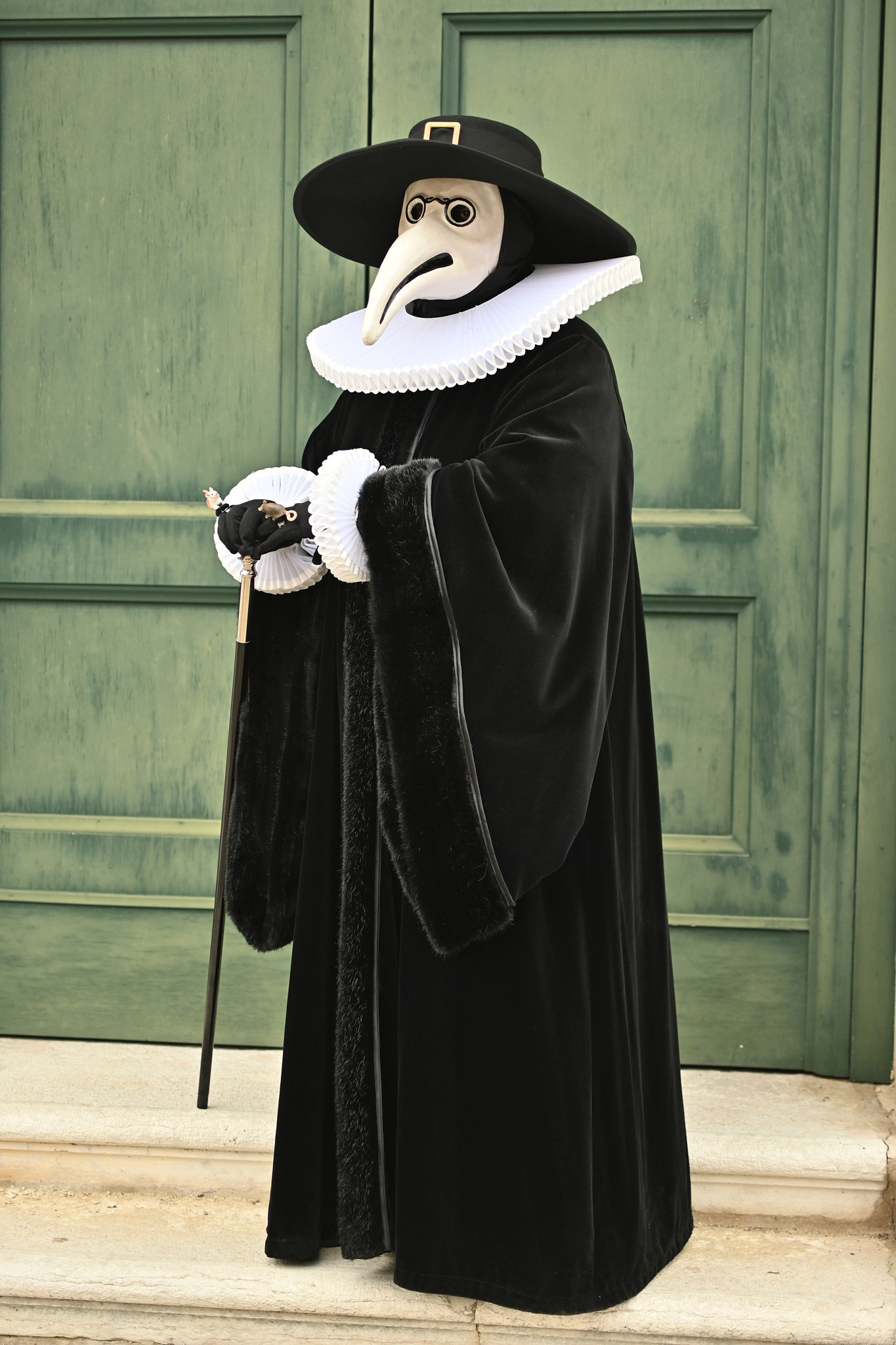 Doctor of Venice. A group of costumed participants walking through the streets of Venice during Carnival. Traditional Venetian masks displayed at the carnival in Venice. The plague doctor mask