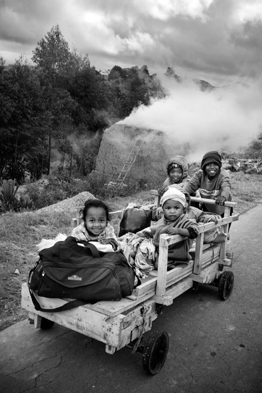 Trolley and child's play, near Alakamisy Ambohimaha, Fianarantsoa II district, Haute Matsiatra region, Fianarantsoa province, Republic of Madagascar. 2011