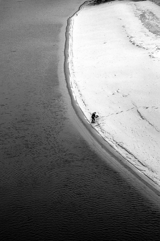 Lone fisherman on the Dniester River in Tiraspol, Pridnestrovian Moldavian Republic. December 2013