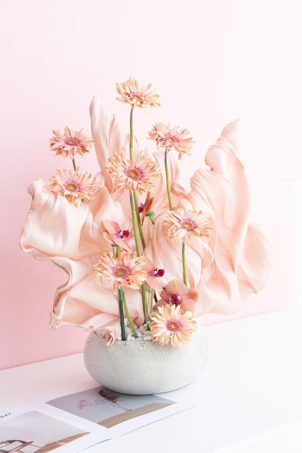 Decorative flower display in a ceramic vase with gentle pastel tones