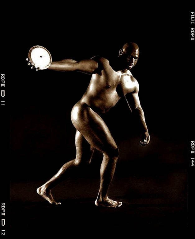 Olympic discus athlete in a monochrome studio portrait.