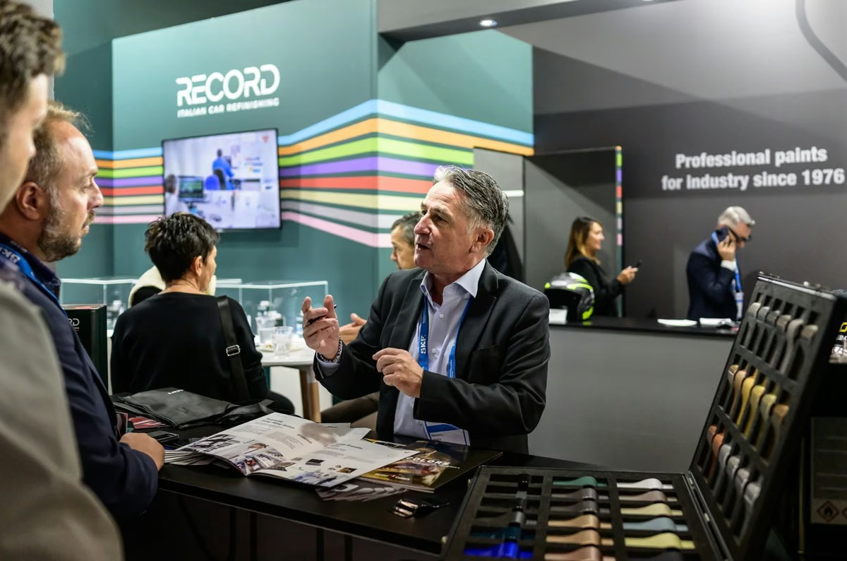 Business professionals networking at an exhibition stand during a corporate event in the UAE