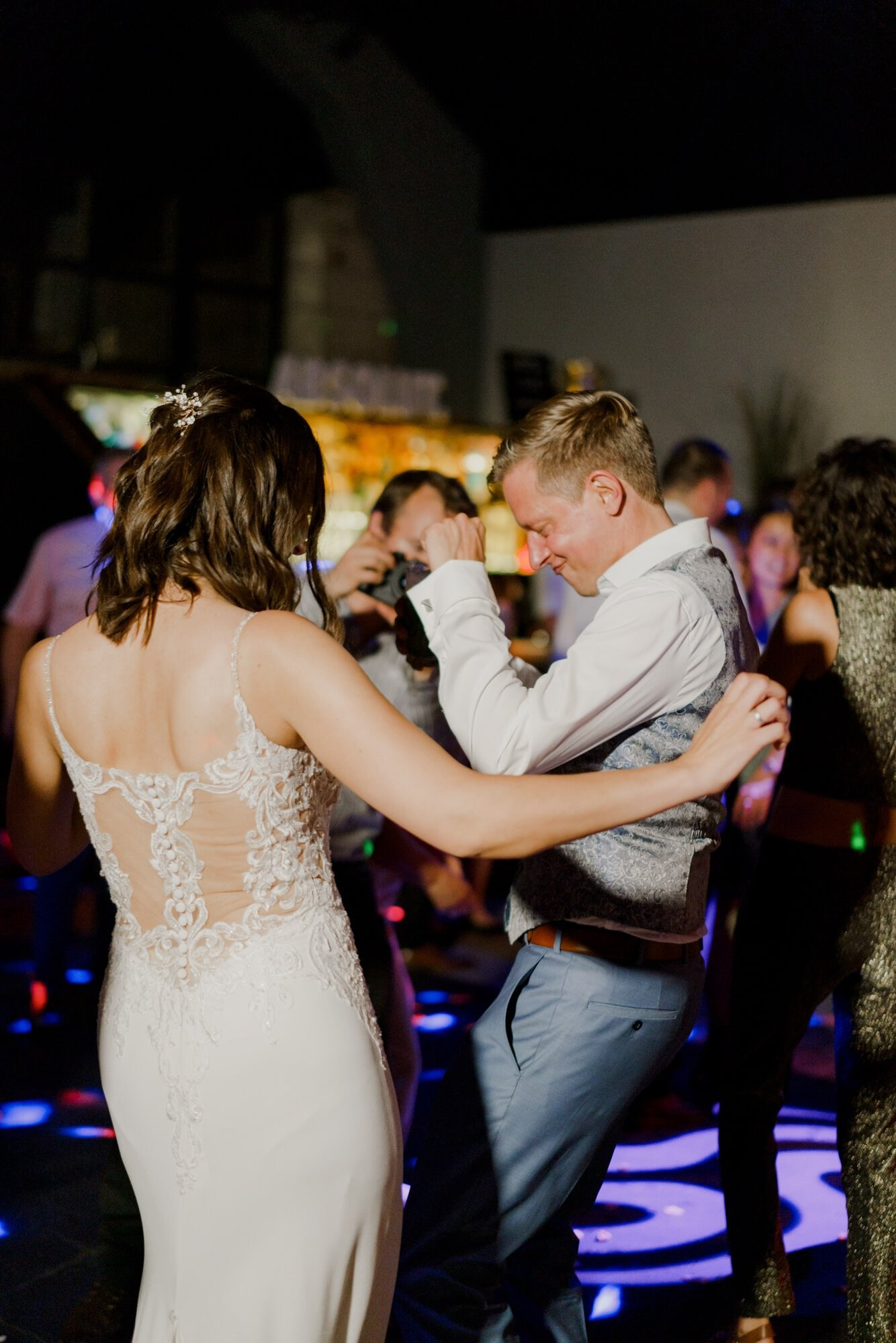 Couple dancing together on a colourful LED dance floor late into the Stuttgart wedding reception