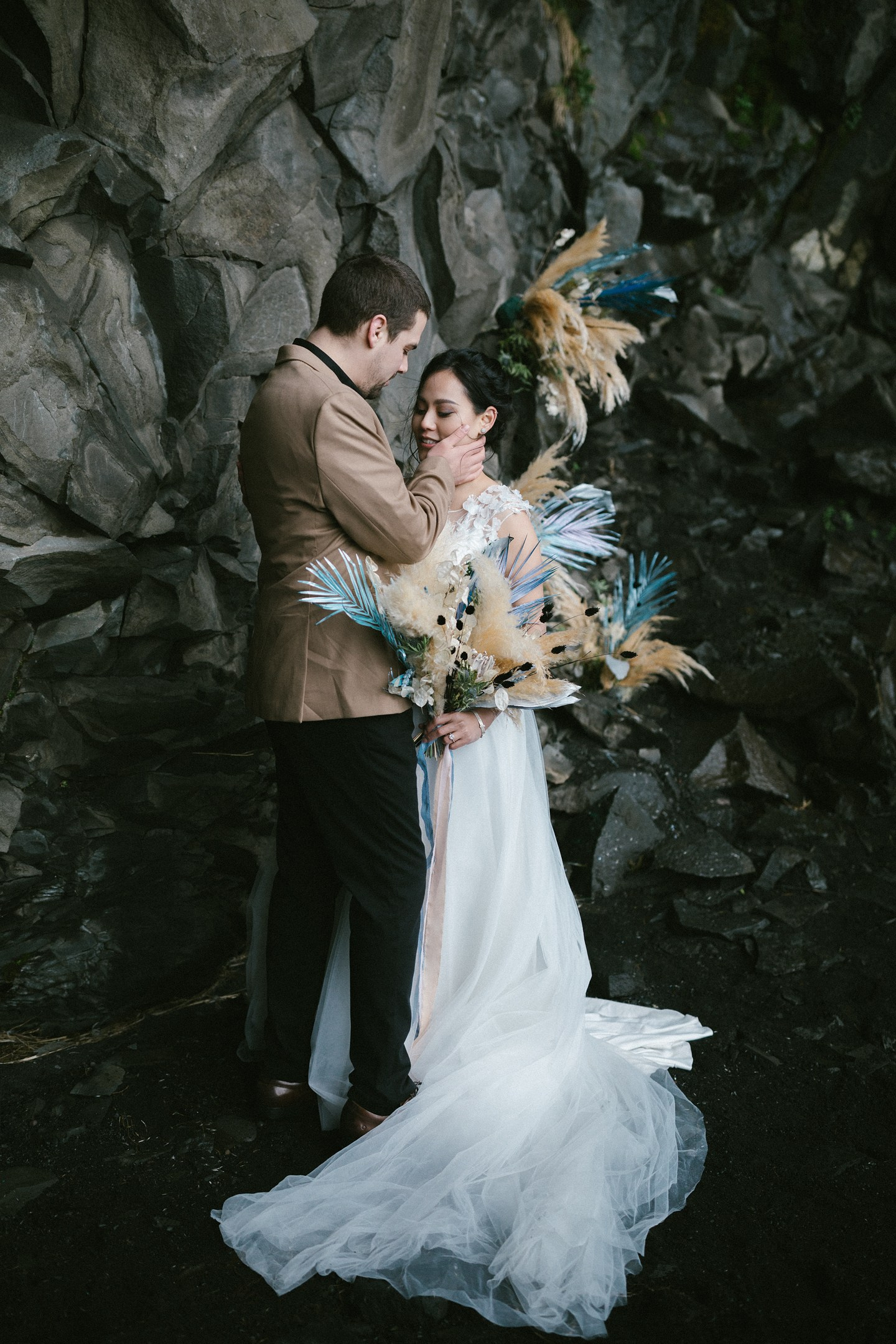 Tender moment by Iceland’s black coastal rocks