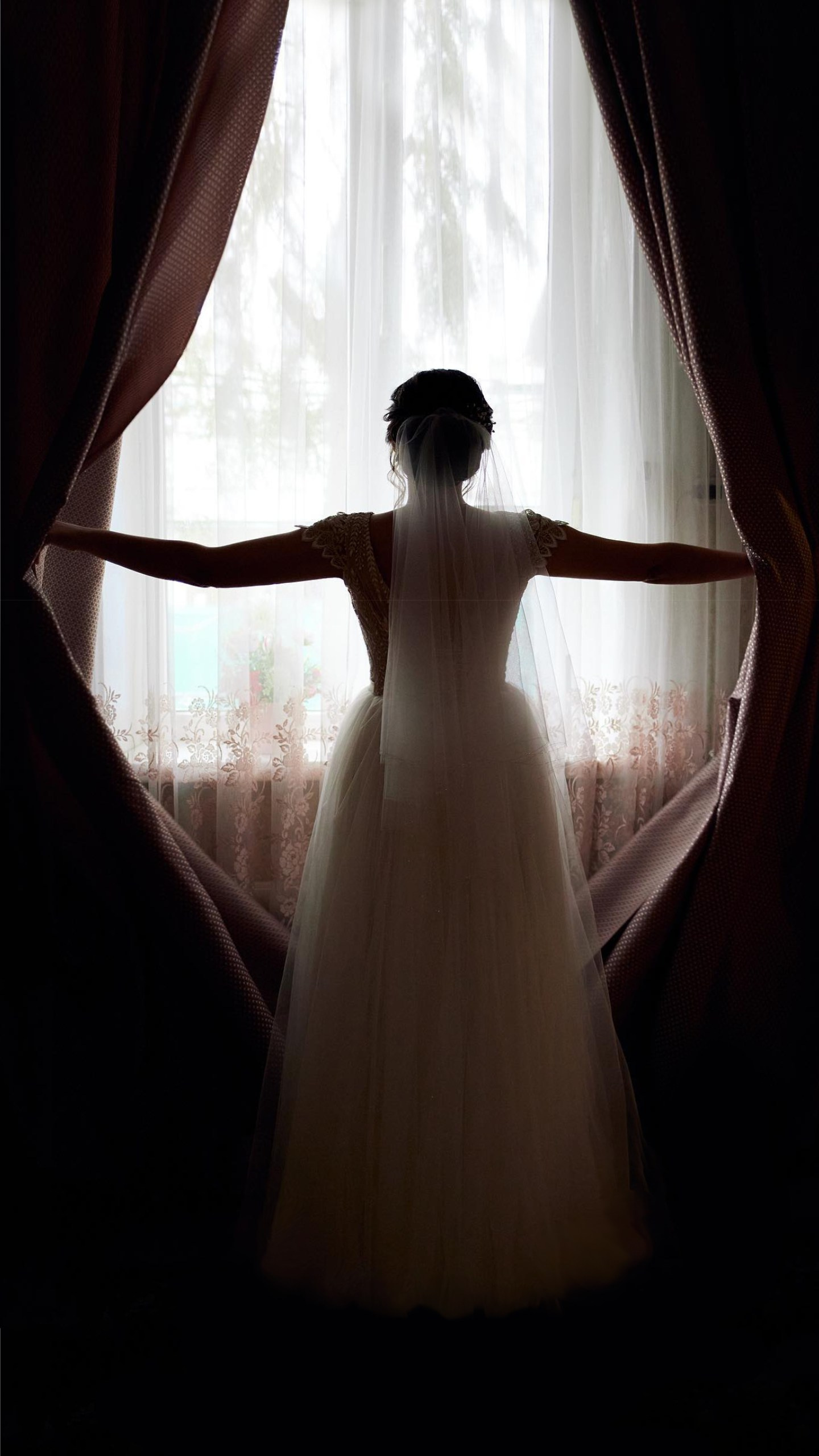 Bride opening the curtains