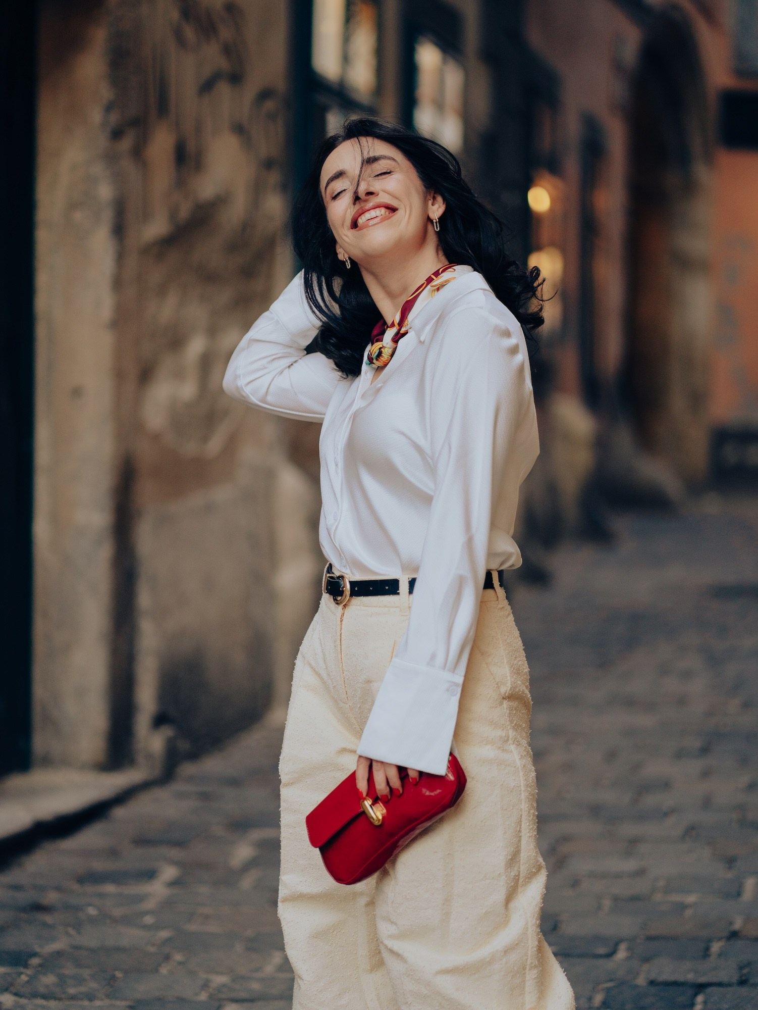 Woman with a red handbag on a quiet Vienna street