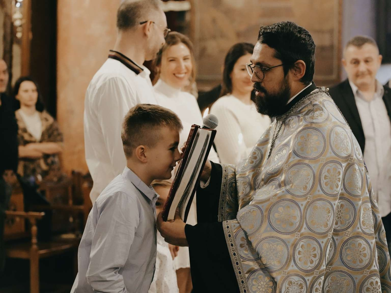 child kissing bible baptism ritual orthodox tradition
