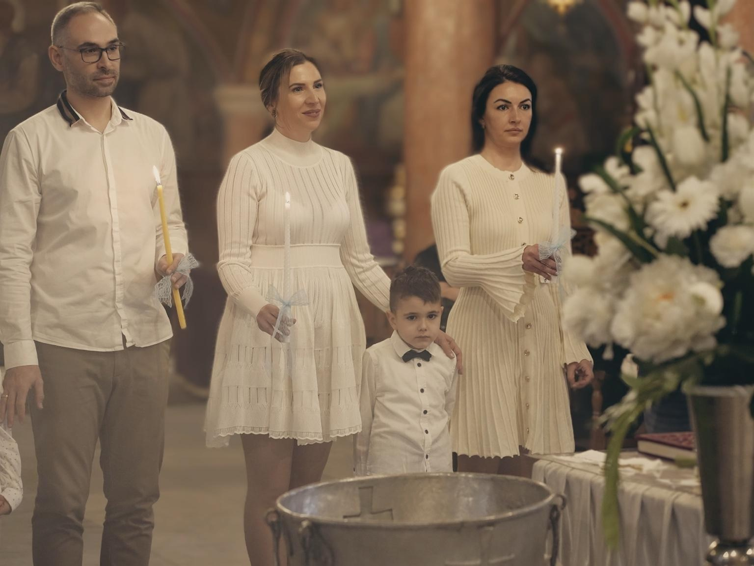 godmother holding child baptism ceremony church