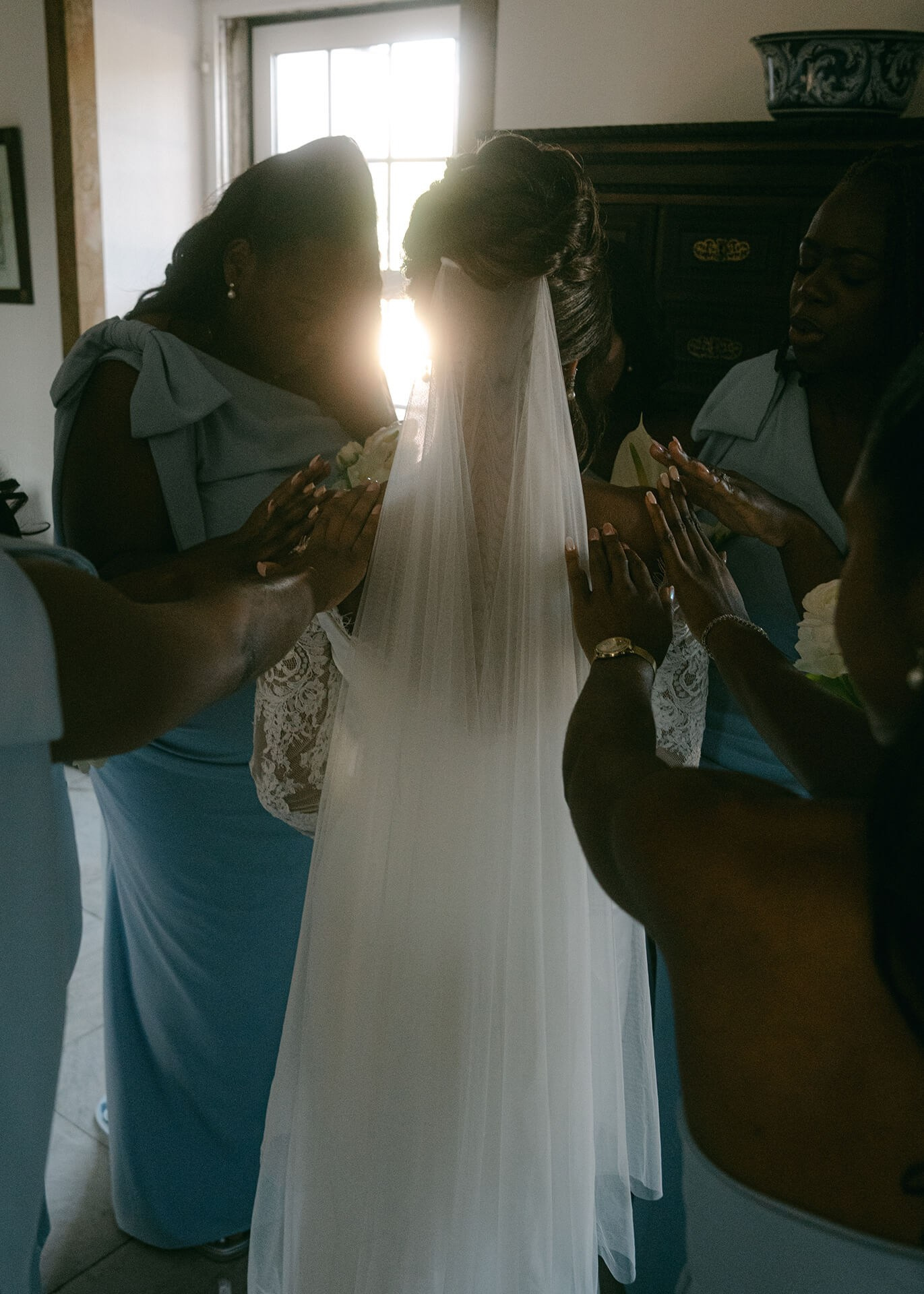 Bride and groom embracing in a silhouette, backlit through a sheer veil at their wedding in Portugal, photography by wedding photographer in Lisbon