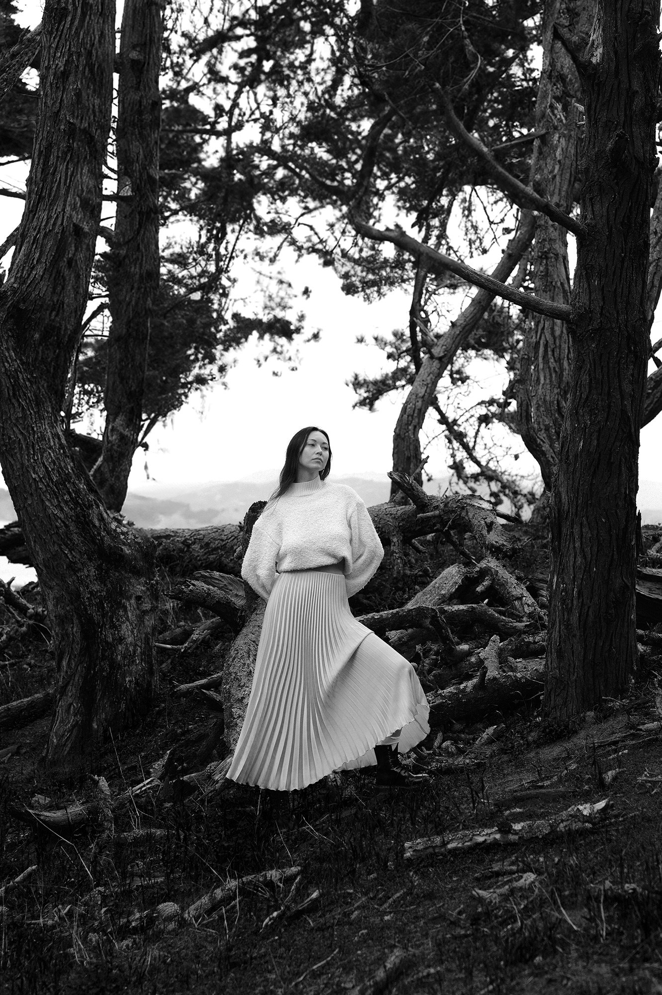 Light and airy professional portrait of a woman in the forest, perfect for fashion portfolio.
