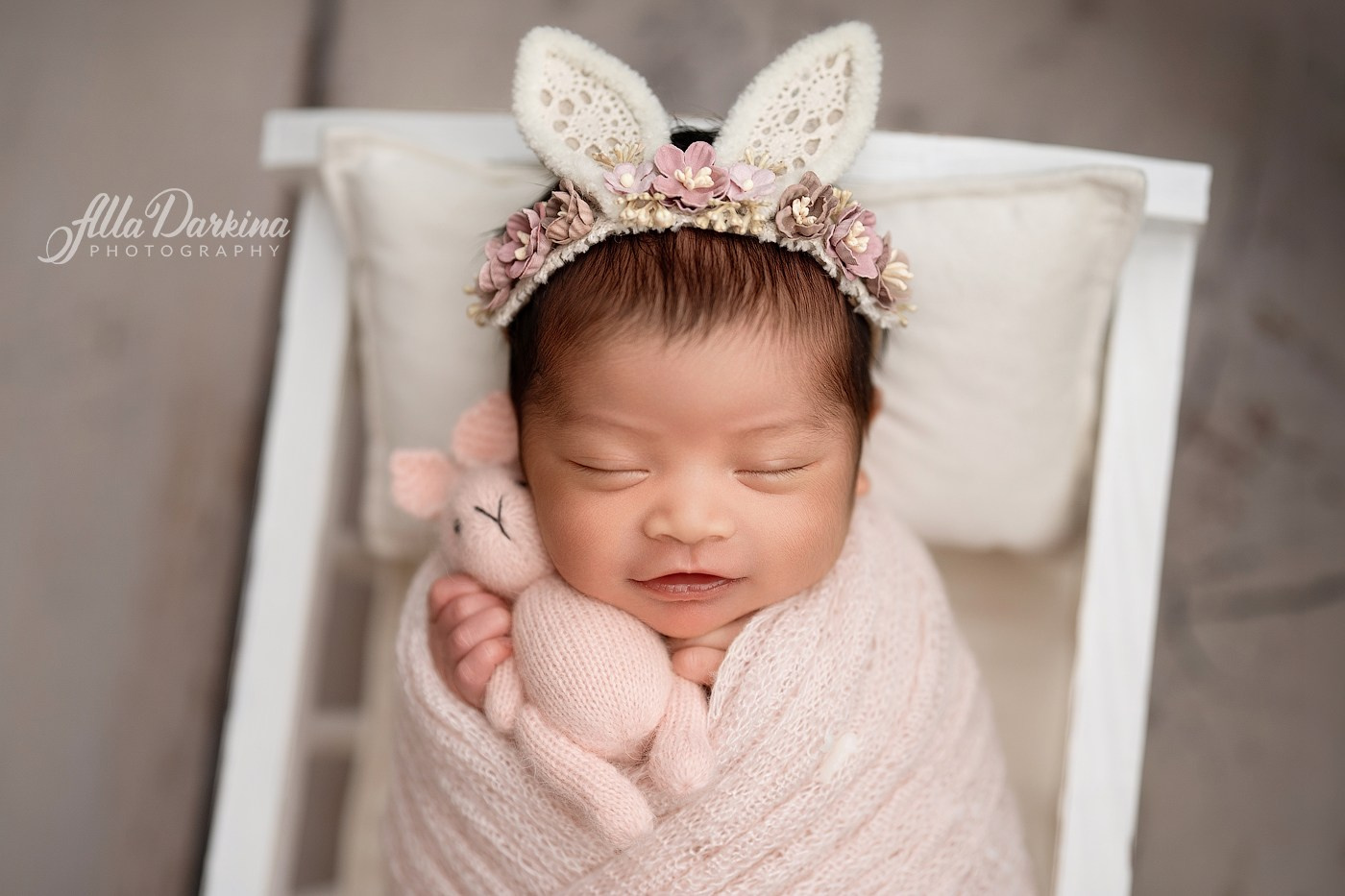 Sleeping newborn baby girl holding a little bunny during a professional newborn photography session in Kellyville, Sydney.