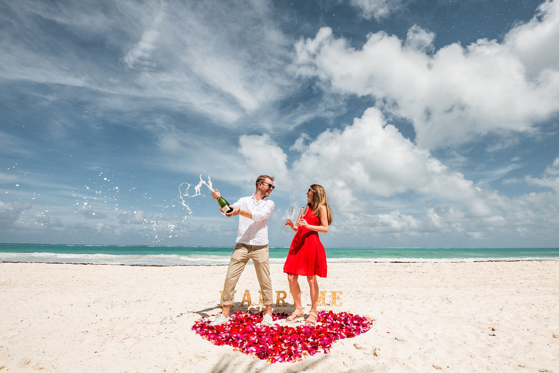 Champagne celebration after romantic beach proposal in Punta Cana