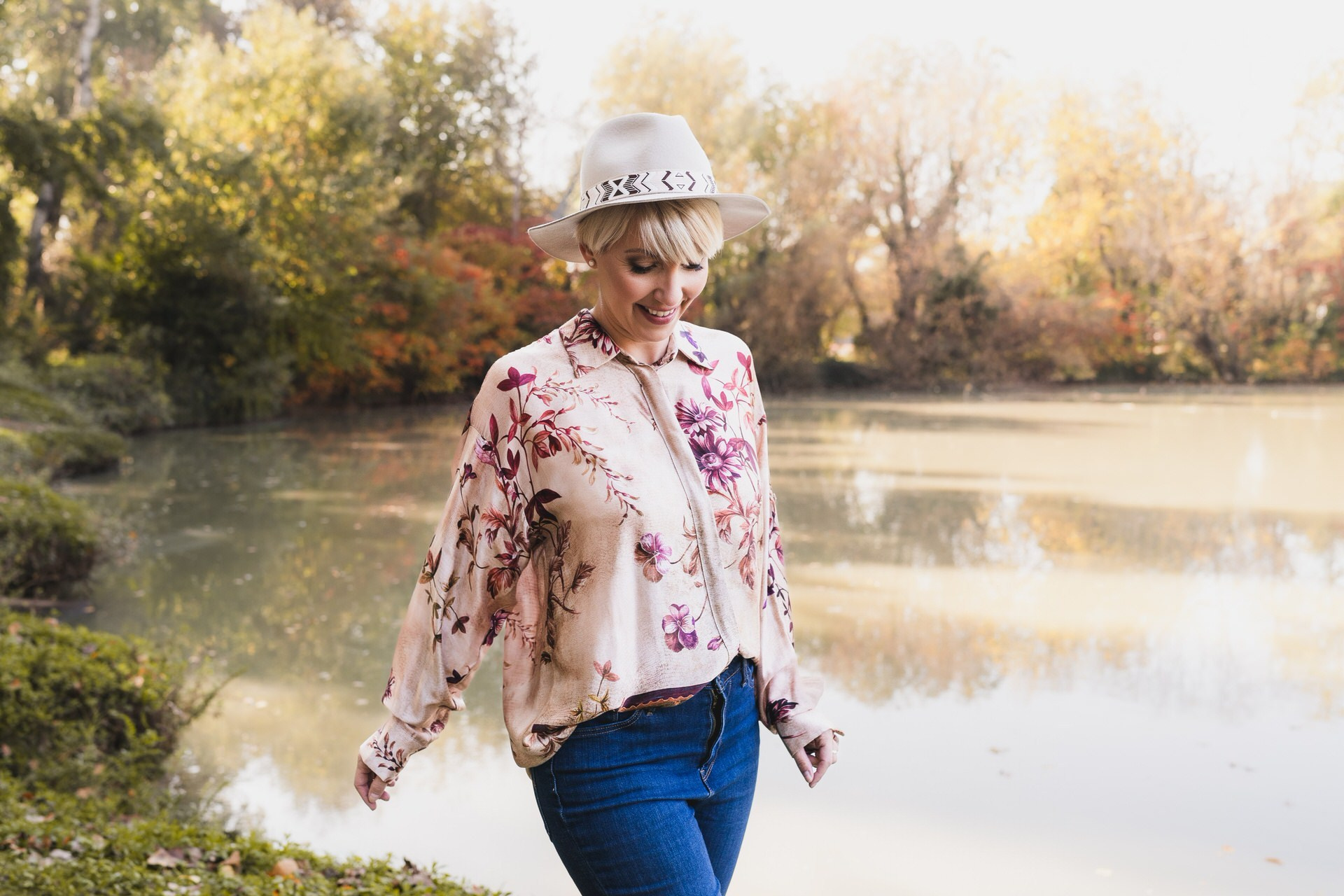 Fotografija žene sa osmehom koja gleda na dole, uhvaćena u pokretu