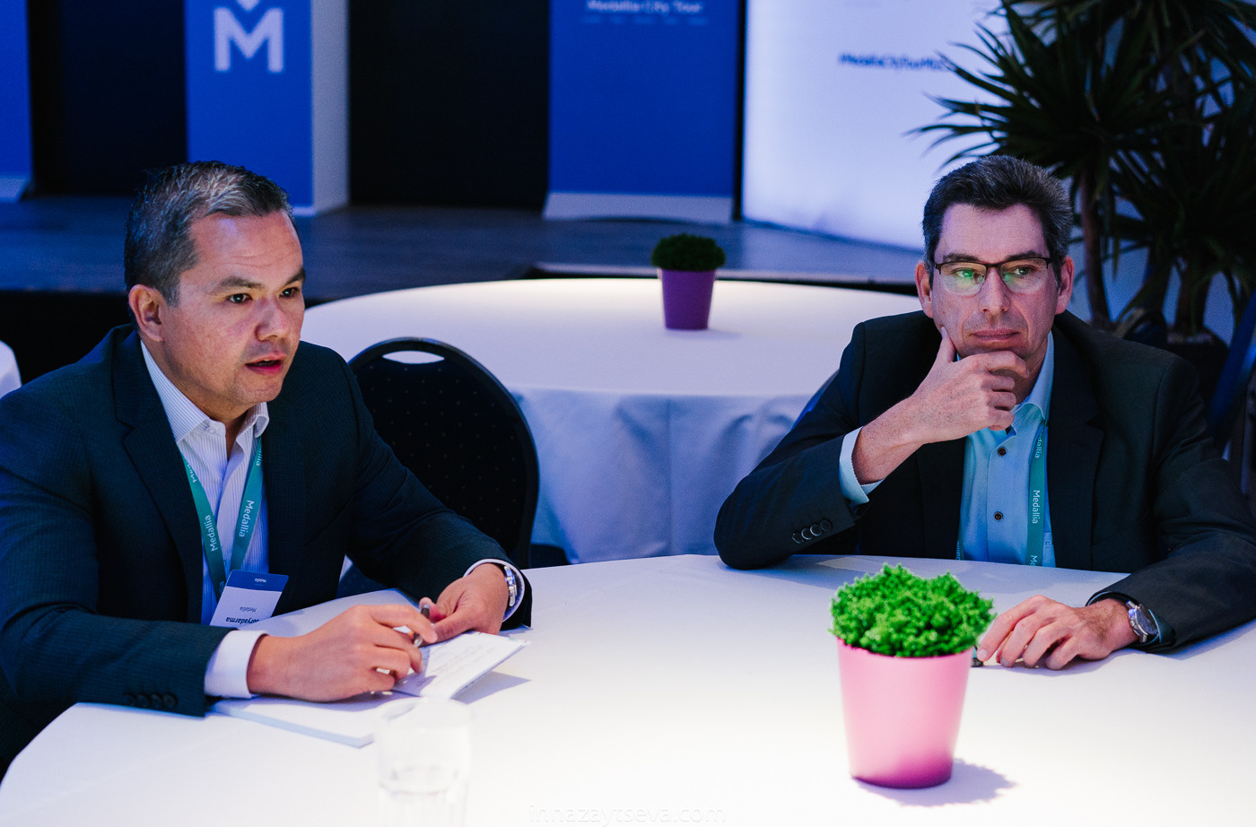 Two company representatives in conversation at a business event