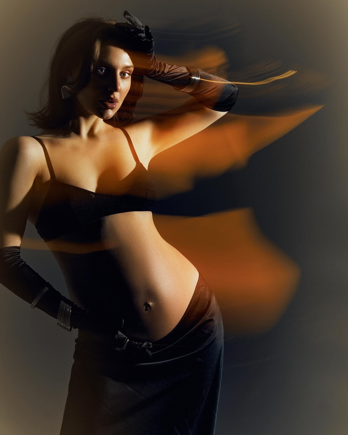 Artistic fashion photography by Hanna Asaulova | Dynamic portrait of model in stylish black lingerie, creative fashion shoot in Vilnius.