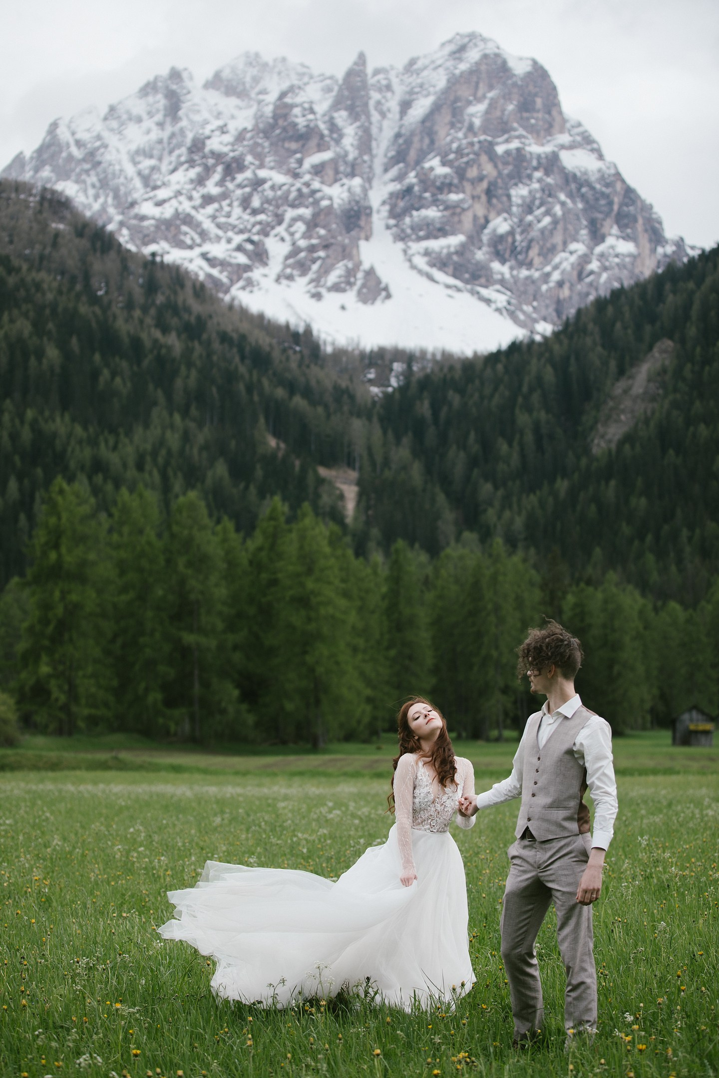 Couple in alpine meadow with Dolomites in the background