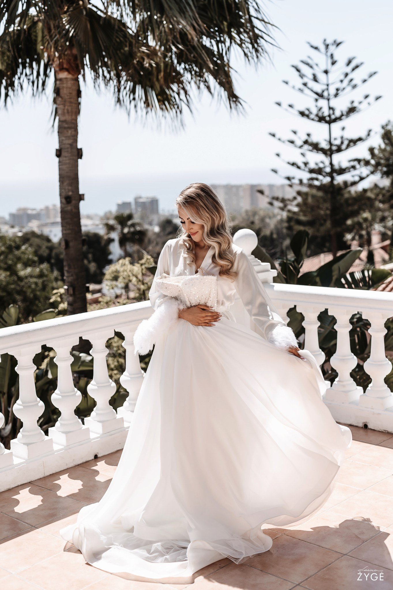 Bridal morning photoshoot with wedding dress and palms