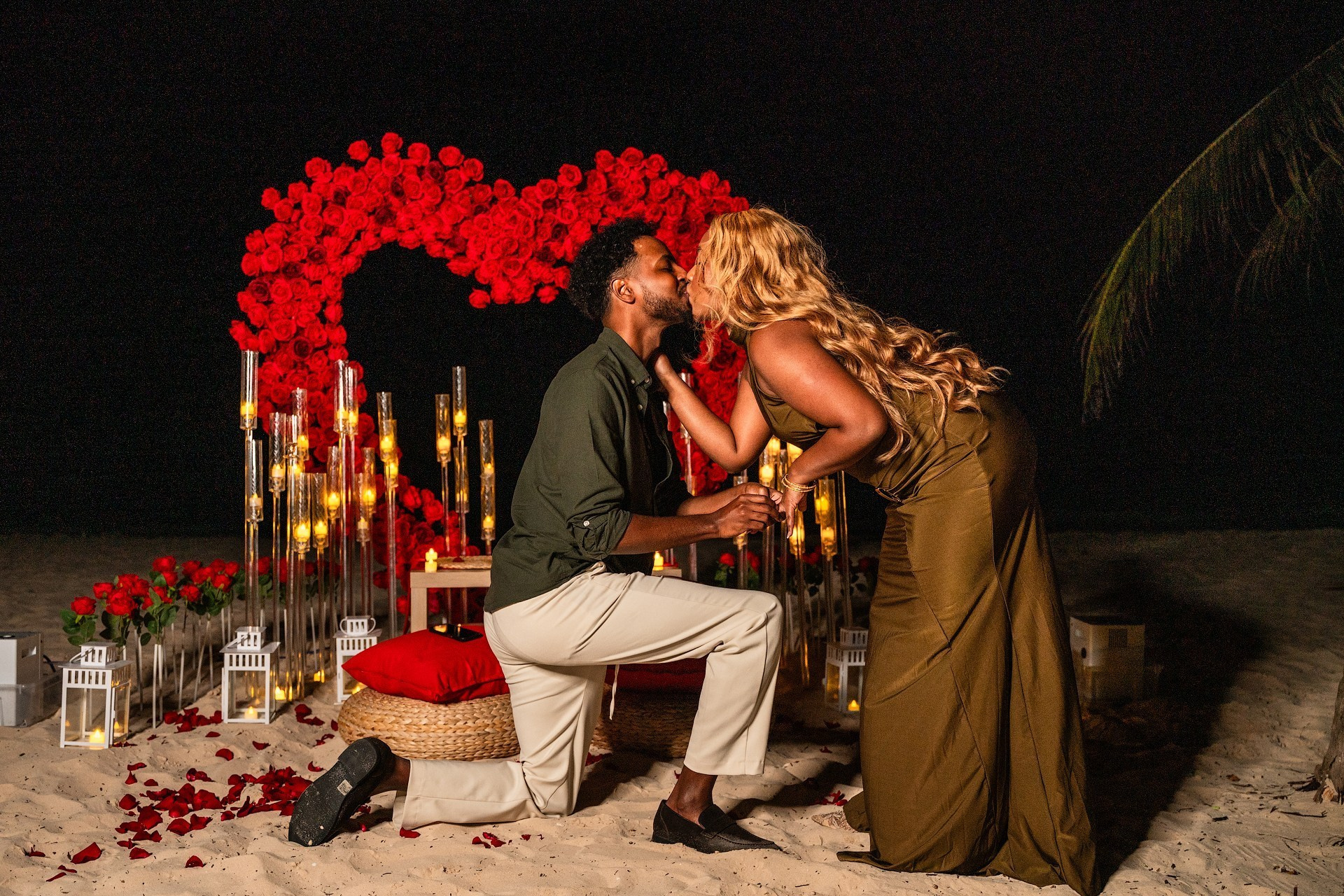 Luxury beach proposal setup with grand red rose heart arch in Punta Cana