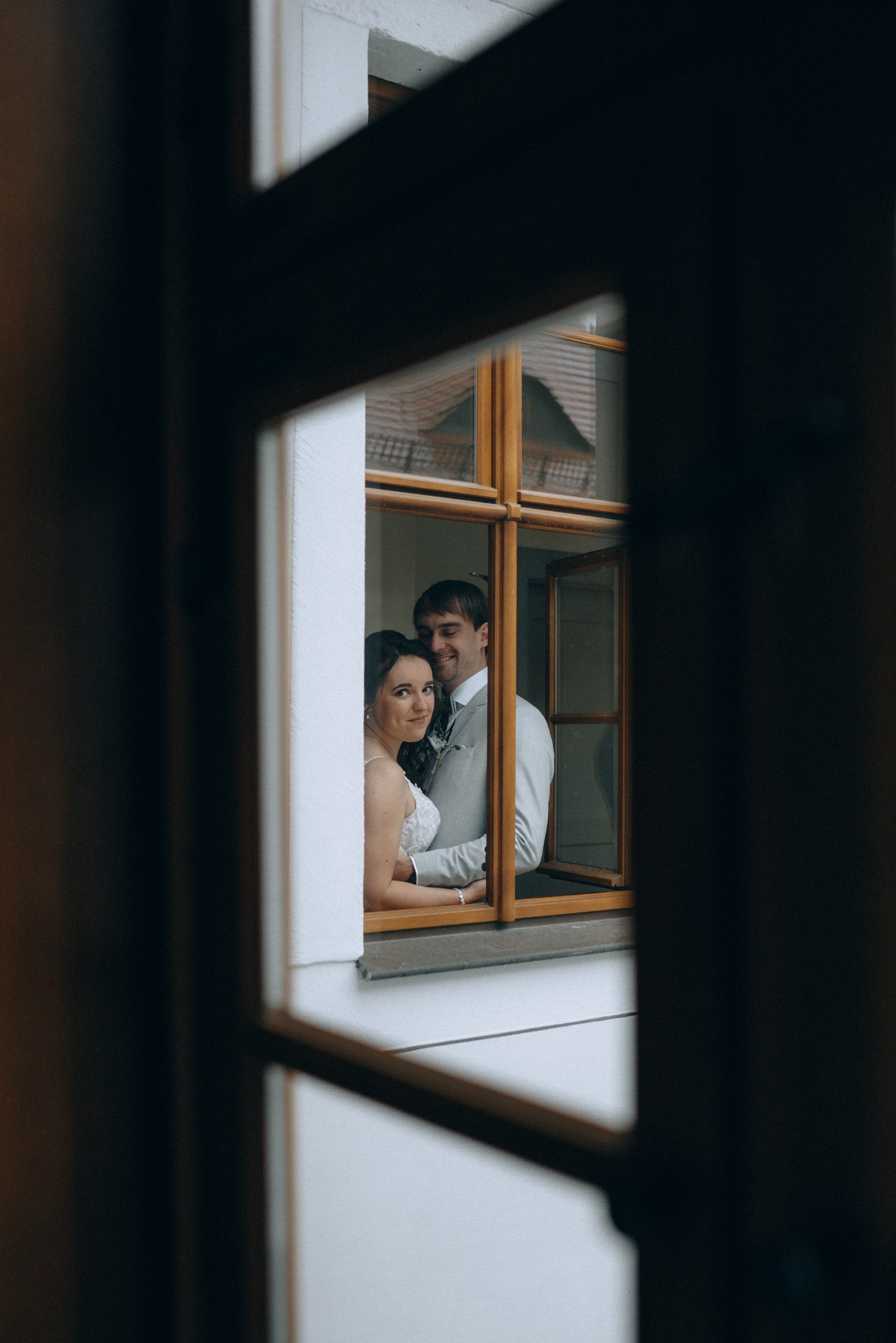 Braut schaut aus dem Fenster – romantische Hochzeitsfotografie Dresden