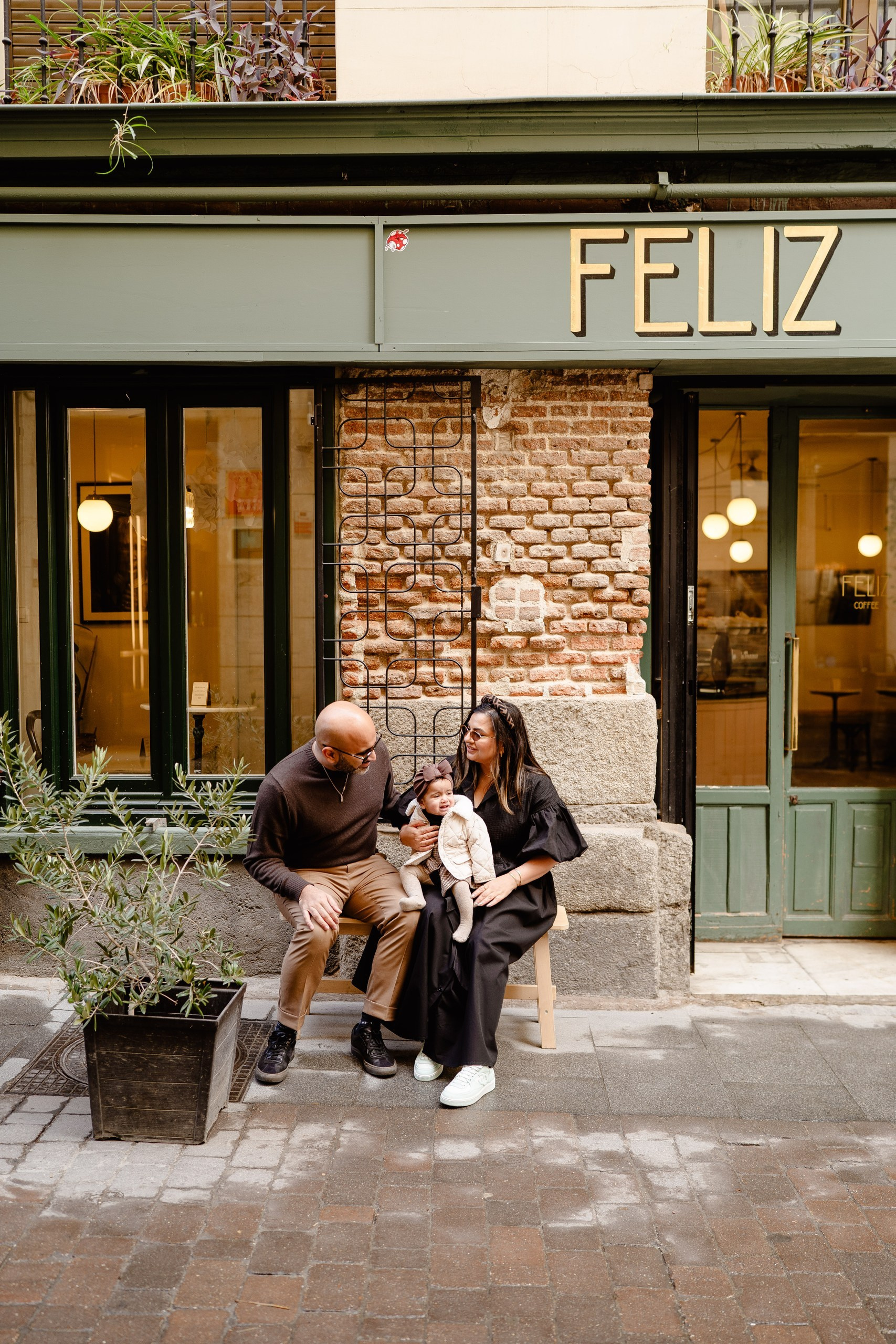 Family enjoying the morning in a Madrid cafe.