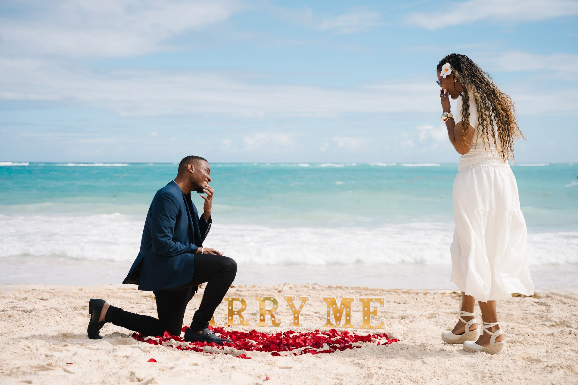 Simple romantic proposal setup on Punta Cana beach with elegant minimal decor