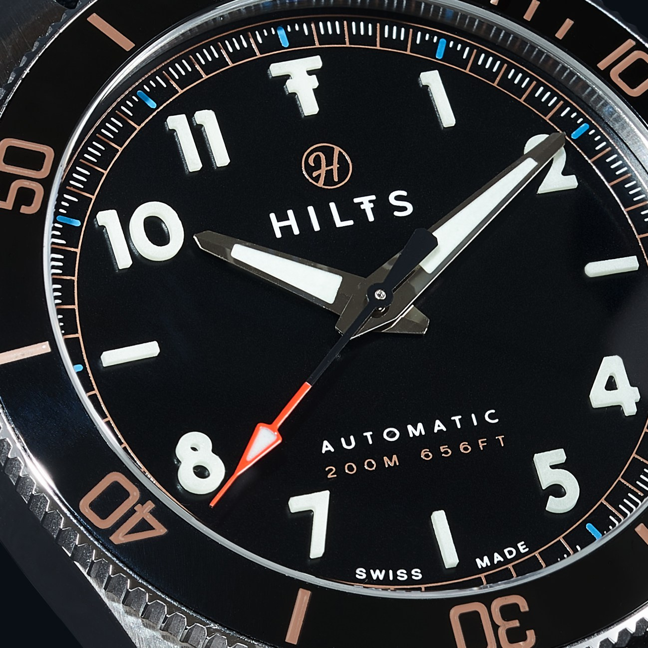 Black dial watch diver watch with rose gold bezel markings, close-up