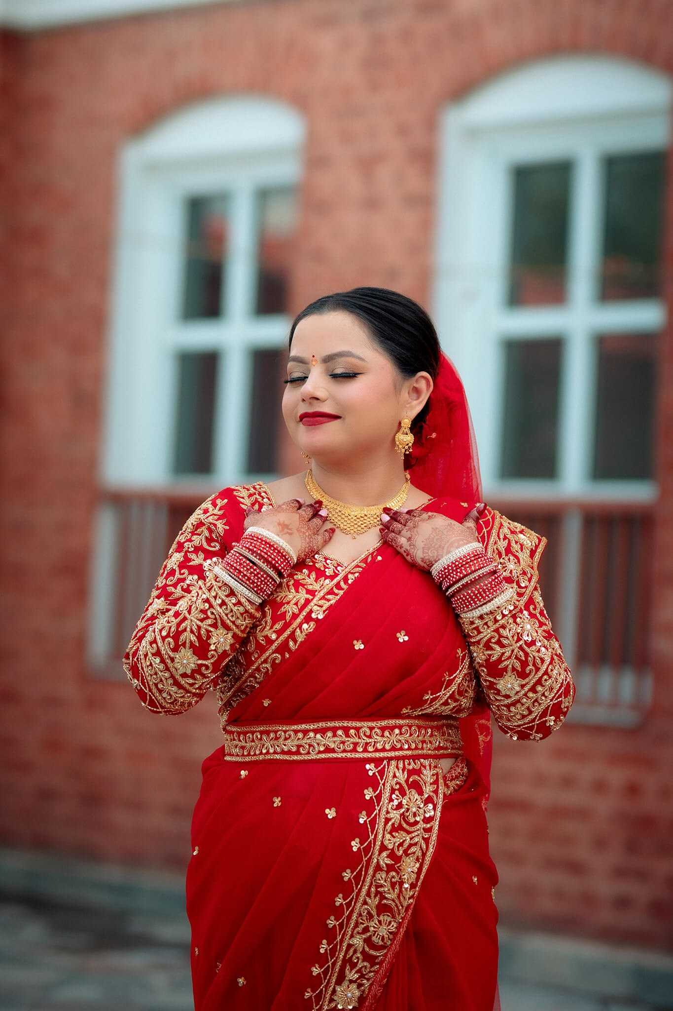 A  Nepali bride posing in a traditional red sari Kathmandu Nepal.