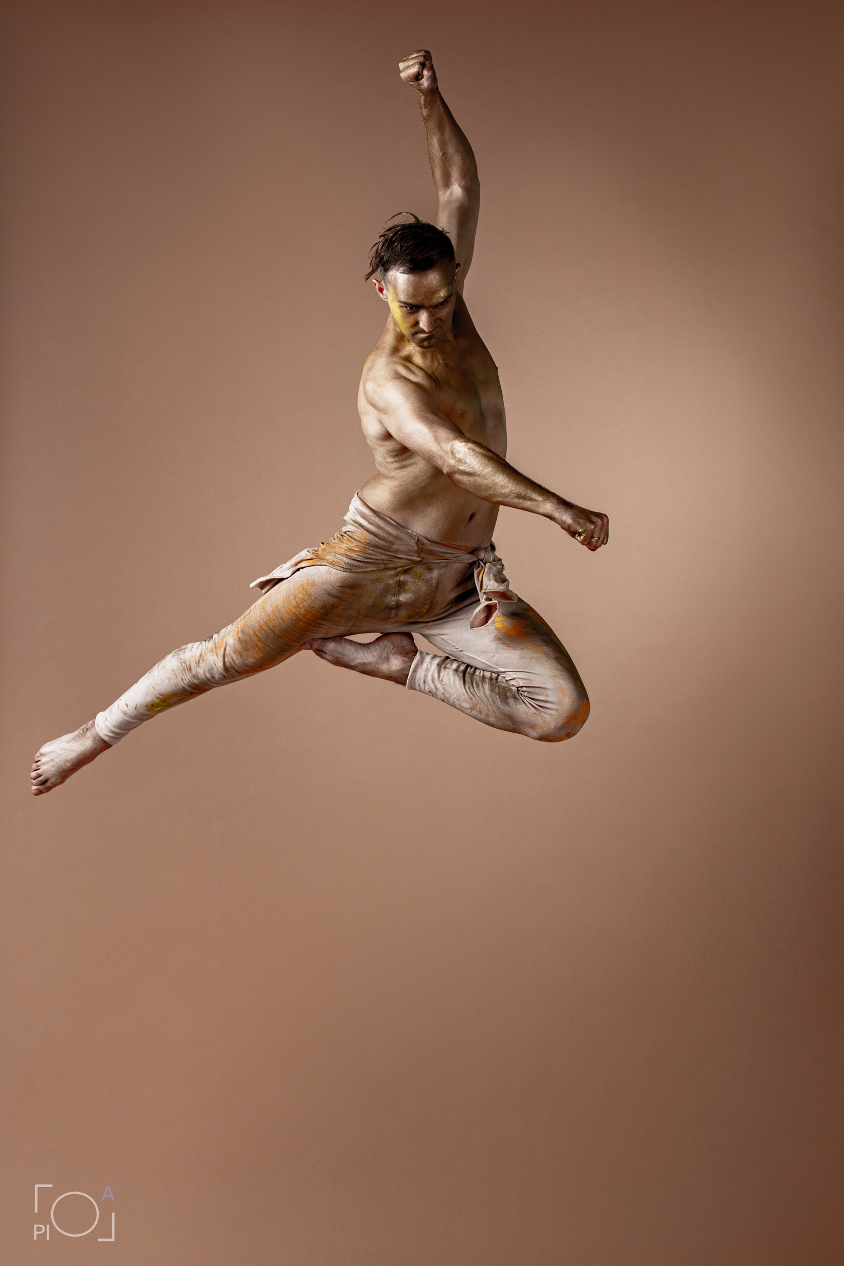 Male dancer in a predatory jump. Studio photo shoot