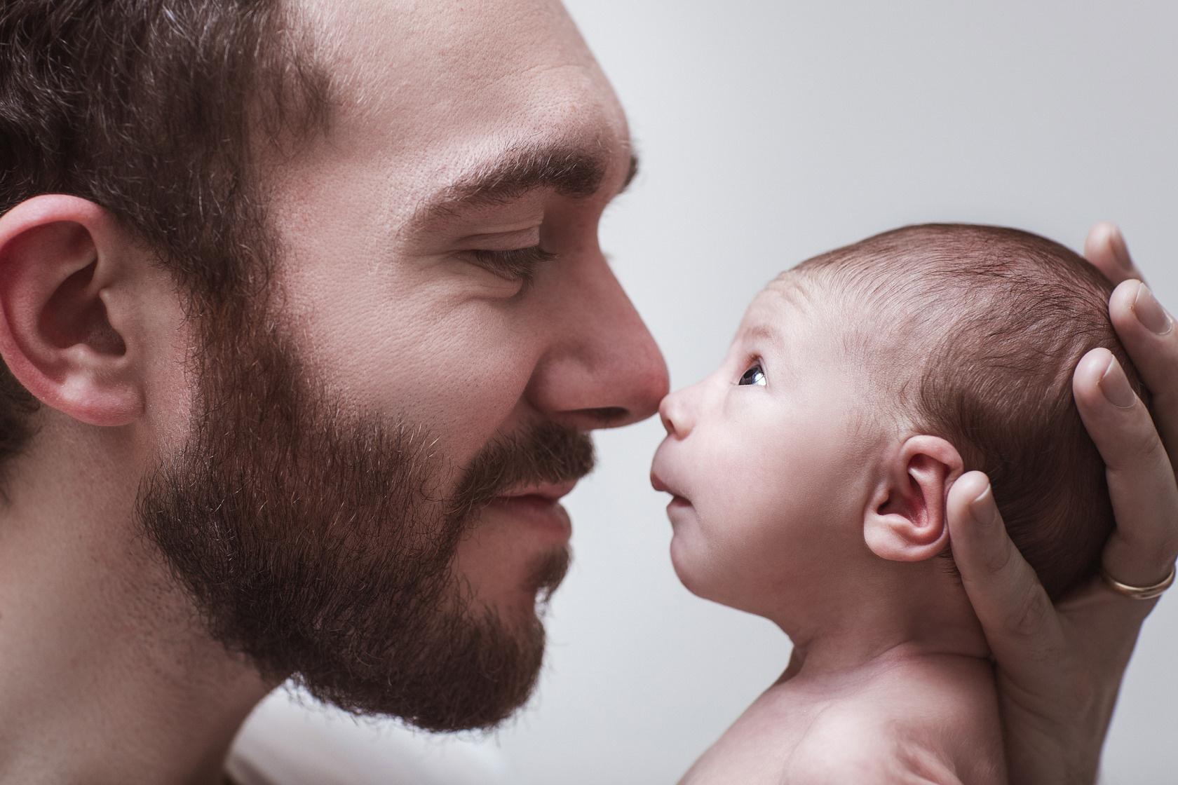 Dad and baby. Touching soulful photo about father and baby relationship, photo shoot at home. Newborn baby.