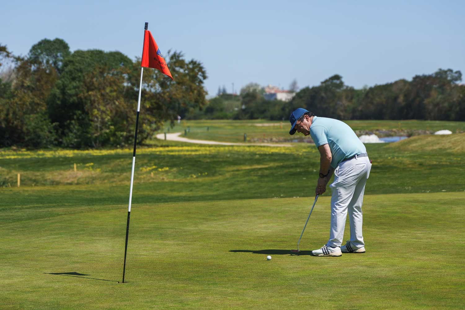 Fotografia desportiva de um golfista num campo de golfe a preparar uma tacada no green, captada em Portugal pela Khave Media