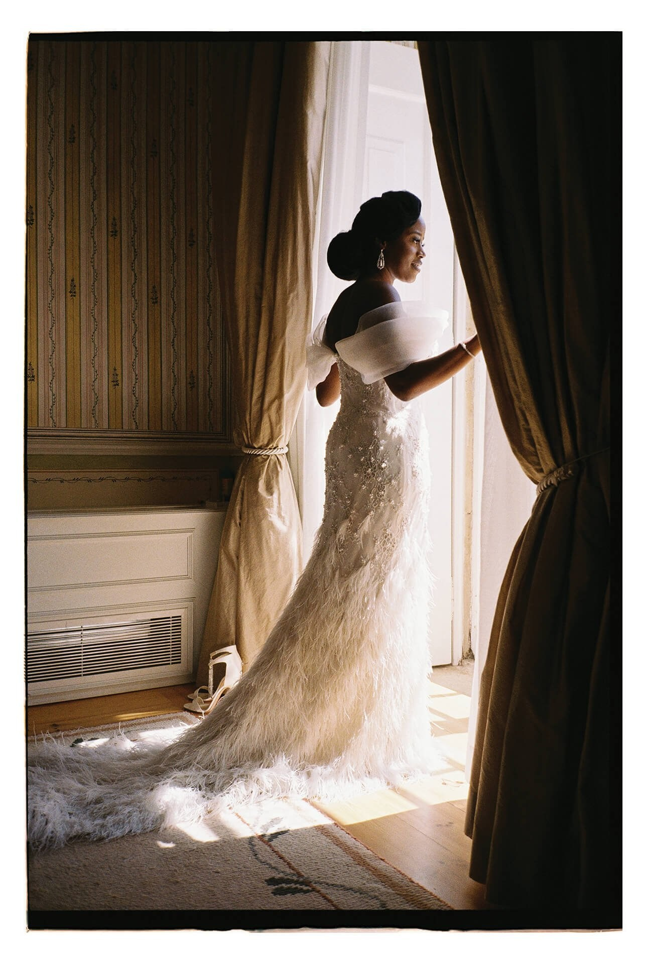 Destination wedding portrait, bride in beaded dress at villa window, Morocco