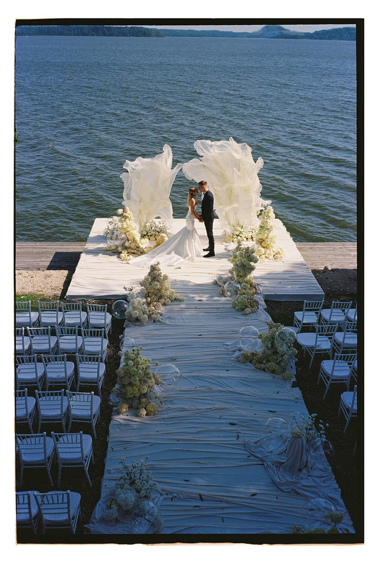 Couple exchanging vows on Lake Como lakeside ceremony platform