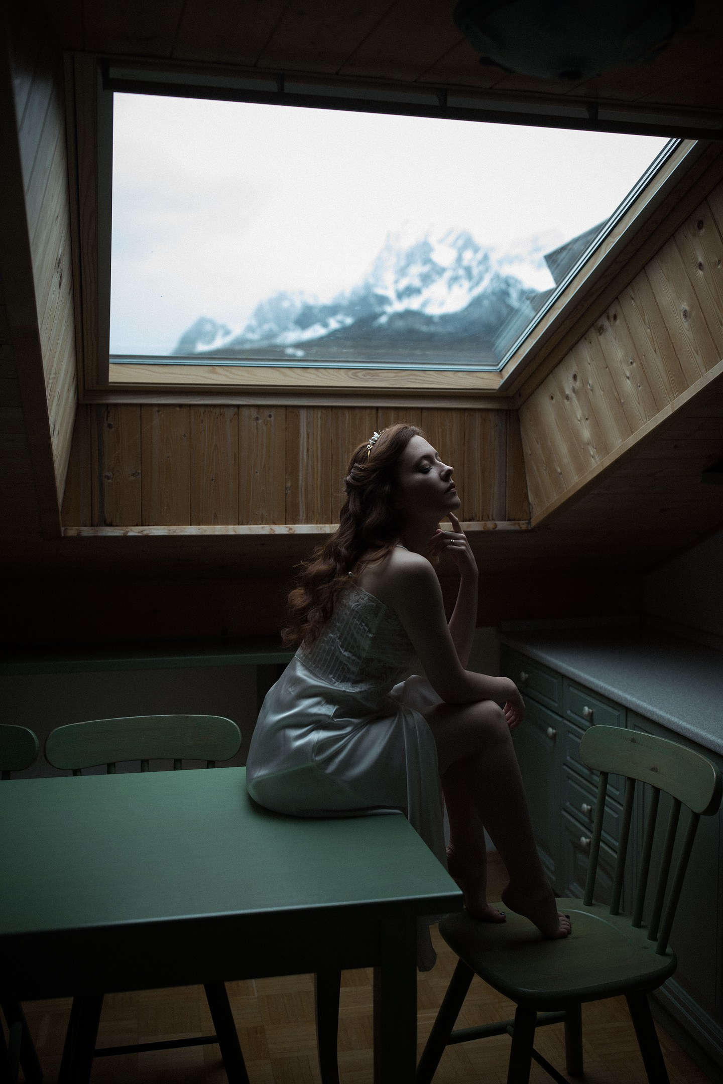 Bride by the window, soft light in the Dolomites