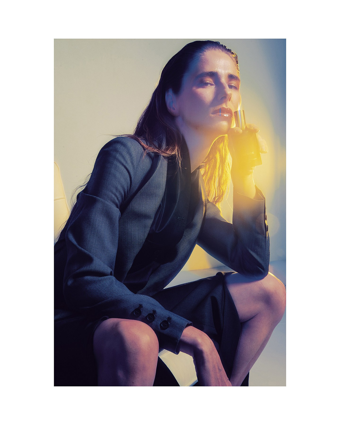 Dramatic lighting highlighting a niche perfume and silhouettes from archival fashion collections. Creative commerce and fashion brand photography, Ambra x The Archivast Collaboration.